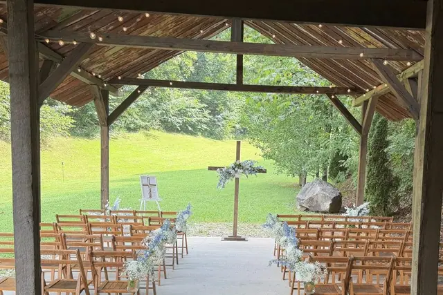 White ceremony chairs set beneath the covered pavilion